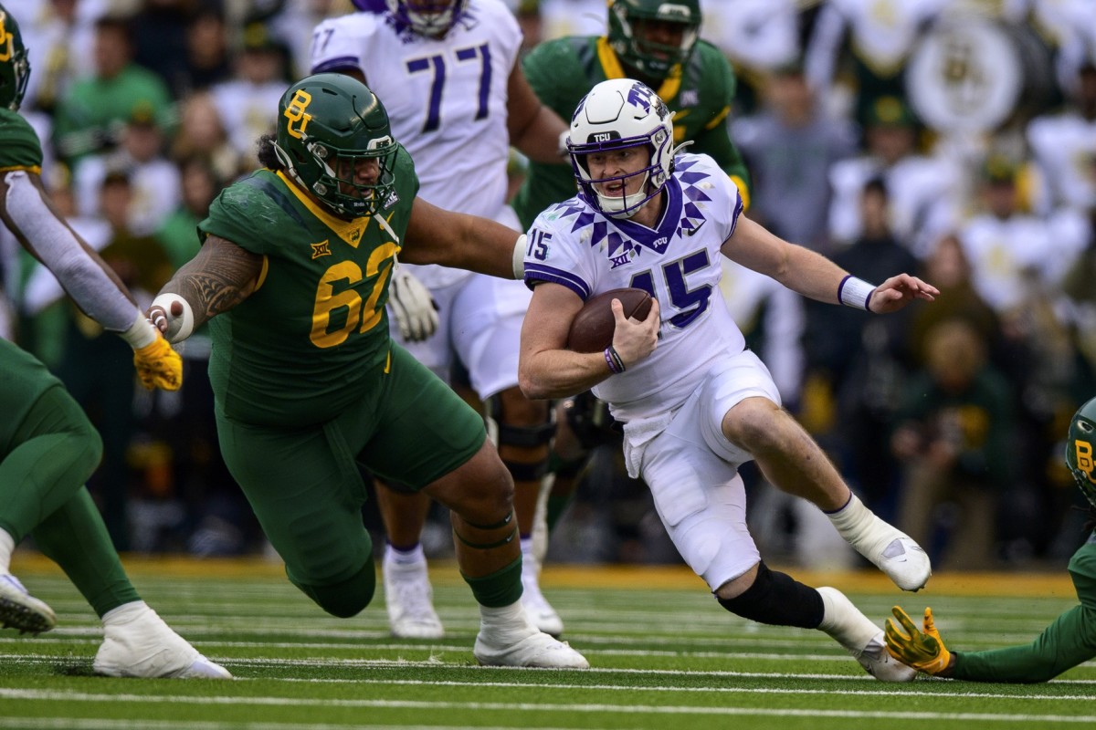 Nov 19, 2022; Waco, Texas, USA; TCU Horned Frogs quarterback Max Duggan (15) is brought down by Baylor Bears defensive lineman Siaki Ika (62) during the second half at McLane Stadium.